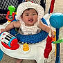 Linoa Grace is registered to the contest to win money with this photo: baby, child, smile, hat, toy, activity_center, indoor, carpet, happy, infant, face, play, cute, colorful, person, seat, young, cheerful, clothing, fun