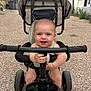 baby, child, tricycle, outdoor, gravel, handlebar, smiling, happy, seat, canopy, toy, play, person, vehicle, summer, cute, infant, expression, transportation, wheel