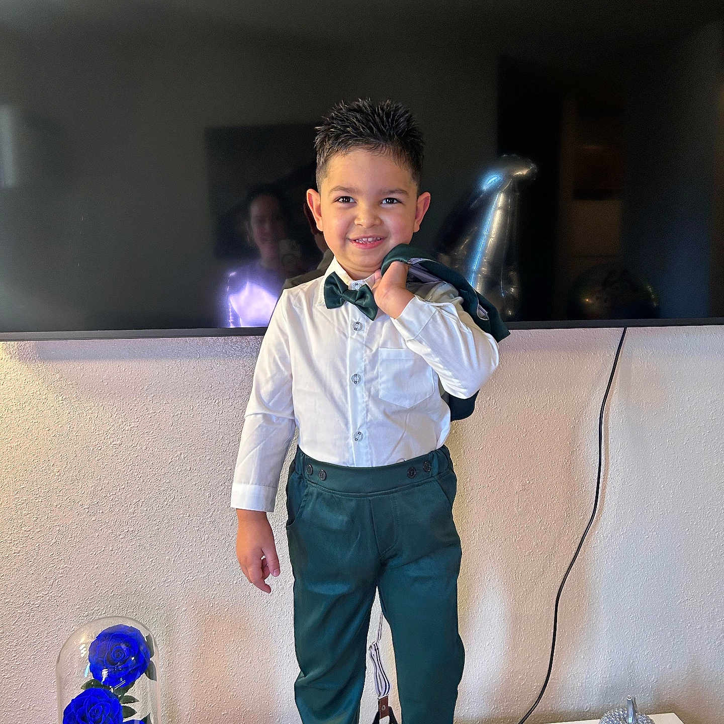 Ian David joined the competition — help win amazing prizes! balloon, bow_tie, boy, child, decorative_rose_under_glass, green_trousers, hairstyle_spiky, home_decor, indoor, jacket, portrait, reflection, smiling, socks, standing, suit, table, television, wall, white_shirt