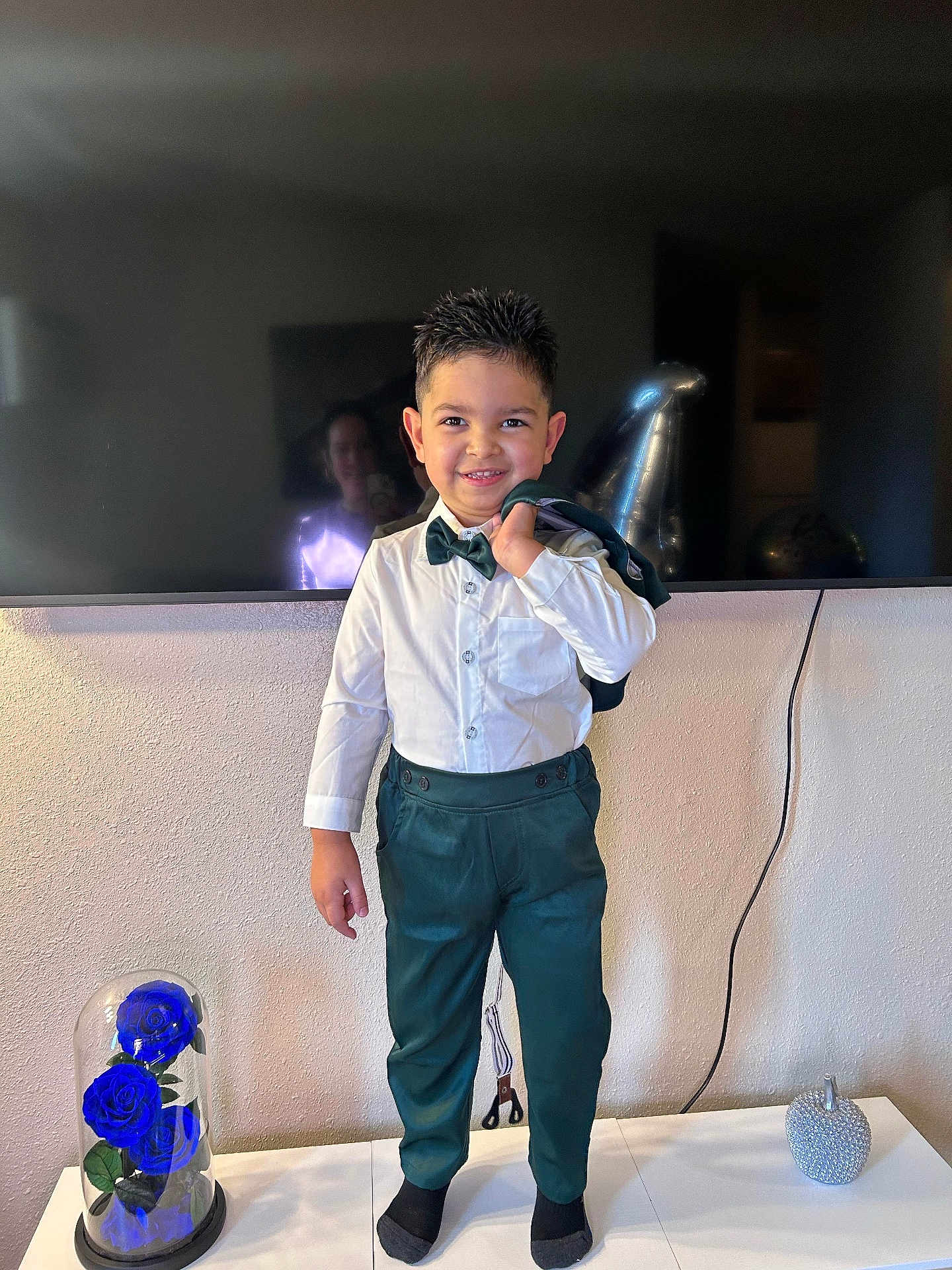 Ian David joined the competition — help win amazing prizes! child, boy, smiling, suit, bow_tie, white_shirt, green_trousers, standing, indoor, portrait, television, reflection, balloon, decorative_rose_under_glass, socks, jacket, hairstyle_spiky, home_decor, table, wall