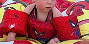 Lucas joined the competition — help win amazing prizes! toddler, child, inflatable_pool, floaties, spiderman, water_toy, outdoor, summer, playtime, swimwear, red, yellow, blue, skin, face, hair, foot, grass, tree, building