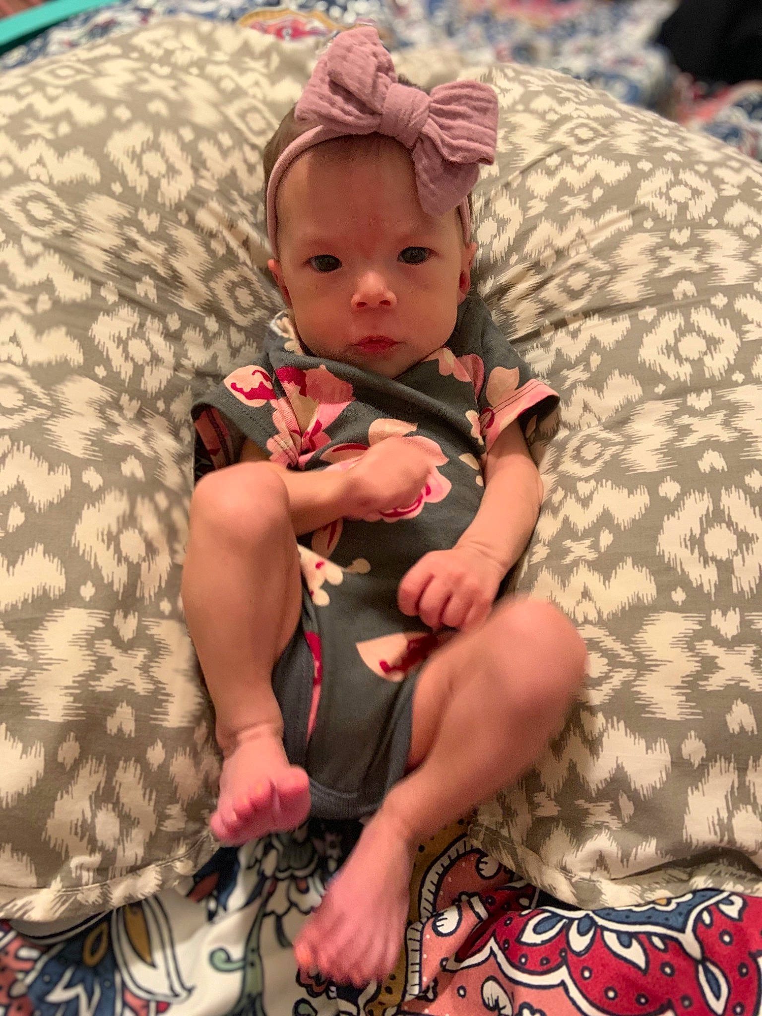 Athena is registered to the contest to win money with this photo: baby, baby_products, baby_toddler_clothing, child, comfort, foot, fun, happy, hat, human_body, human_leg, lap, pattern, person, sandal, sitting, skin, sock, textile, thigh