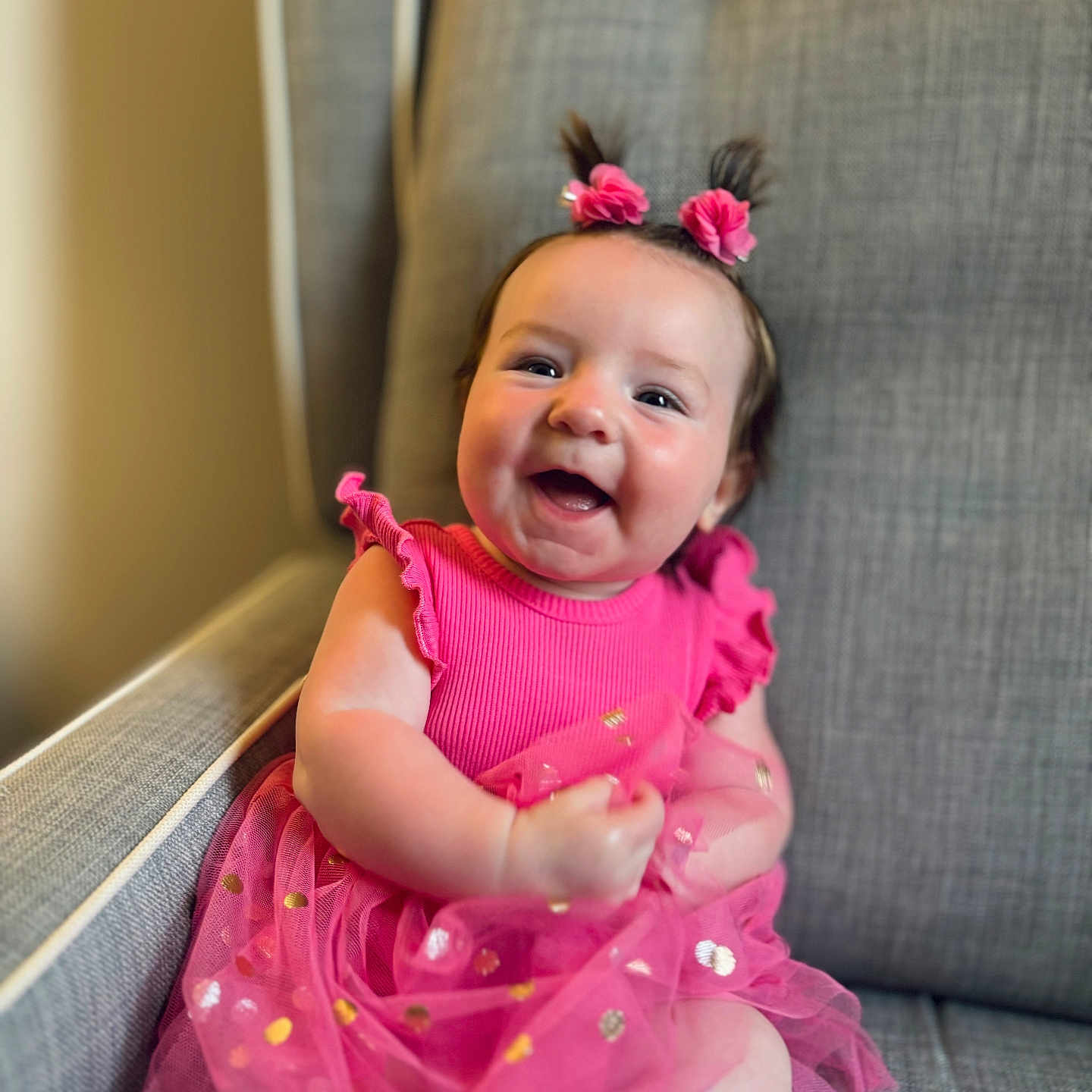 Raelynn is registered to the contest to win money with this photo: accessories, baby, babylaughing, clothing, couch, cushion, dress, face, furniture, happy, head, homedecor, jewelry, laughing, necklace, person, photography, portrait, sitting, smile