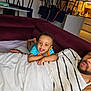 Matteo a rejoint le concours — aidez-le/la à gagner de superbes lots ! toddler, child, smiling, couch, maroon, blanket, striped_shirt, adult, living_room, kitchen, relaxing, happy, indoor, family, playful, curly_hair, person, furniture, home, casual