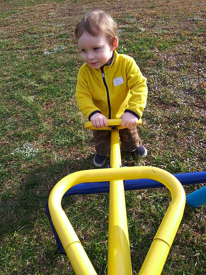 Zachary is registered to the contest to win money with this photo: child, grass, leisure, outdoor_play_equipment, person, play, playground, public_space, recreation, toddler, yellow