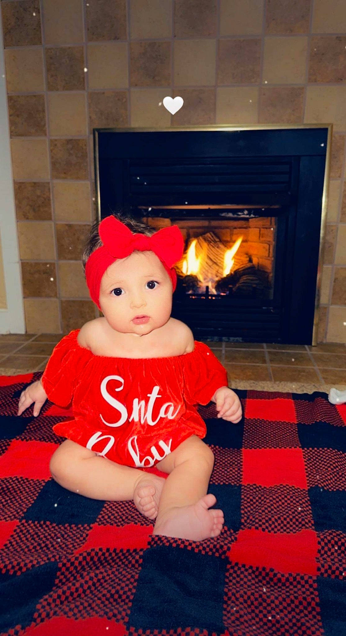 Blakelynn joined the competition — help win amazing prizes! baby_toddler_clothing, carmine, fire_screen, fireplace, floor, flooring, gas, headwear, hearth, heat, holiday, living_room, masonry_oven, orange, pattern, person, room, stove, toddler, toy