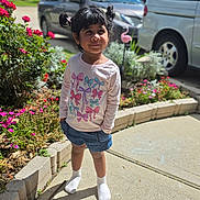 Esah Mariyam is registered to the contest to win money with this photo: child, girl, outdoor, sunny, flowers, pigtails, shirt, shorts, socks, sidewalk, car, minivan, garden, plants, bowl, playful, cute, smiling, daytime, residential