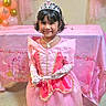 Esah Mariyam is registered to the contest to win money with this photo: child, girl, birthday_party, princess_costume, tiara, pink_dress, gloves, necklace, balloons, party_decoration, banner, smile, indoor, carpet, table, celebration, festive, young_child, cute, portrait