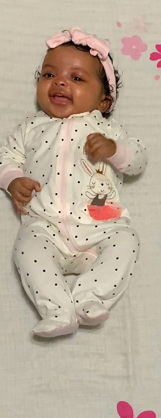 Amarie is registered to the contest to win money with this photo: baby, baby_products, baby_toddler_clothing, carmine, child, pattern, person, plush, sitting, sleeve, smile, stuffed_toy, thumb, toddler, toy, white