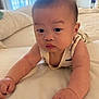 Tristan is registered to the contest to win money with this photo: baby, infant, bed, arms, face, skin, clothing, furniture, indoor, curious, cute, person, child, portrait, expression, resting, soft, blanket, sleepwear, room