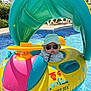 baby, child, pool, inflatable, float, sunglasses, hat, water, summer, sunlight, outdoor, swimming_pool, toy, colorful, fun, vacation, leisure, sun_protection, relaxation, floating