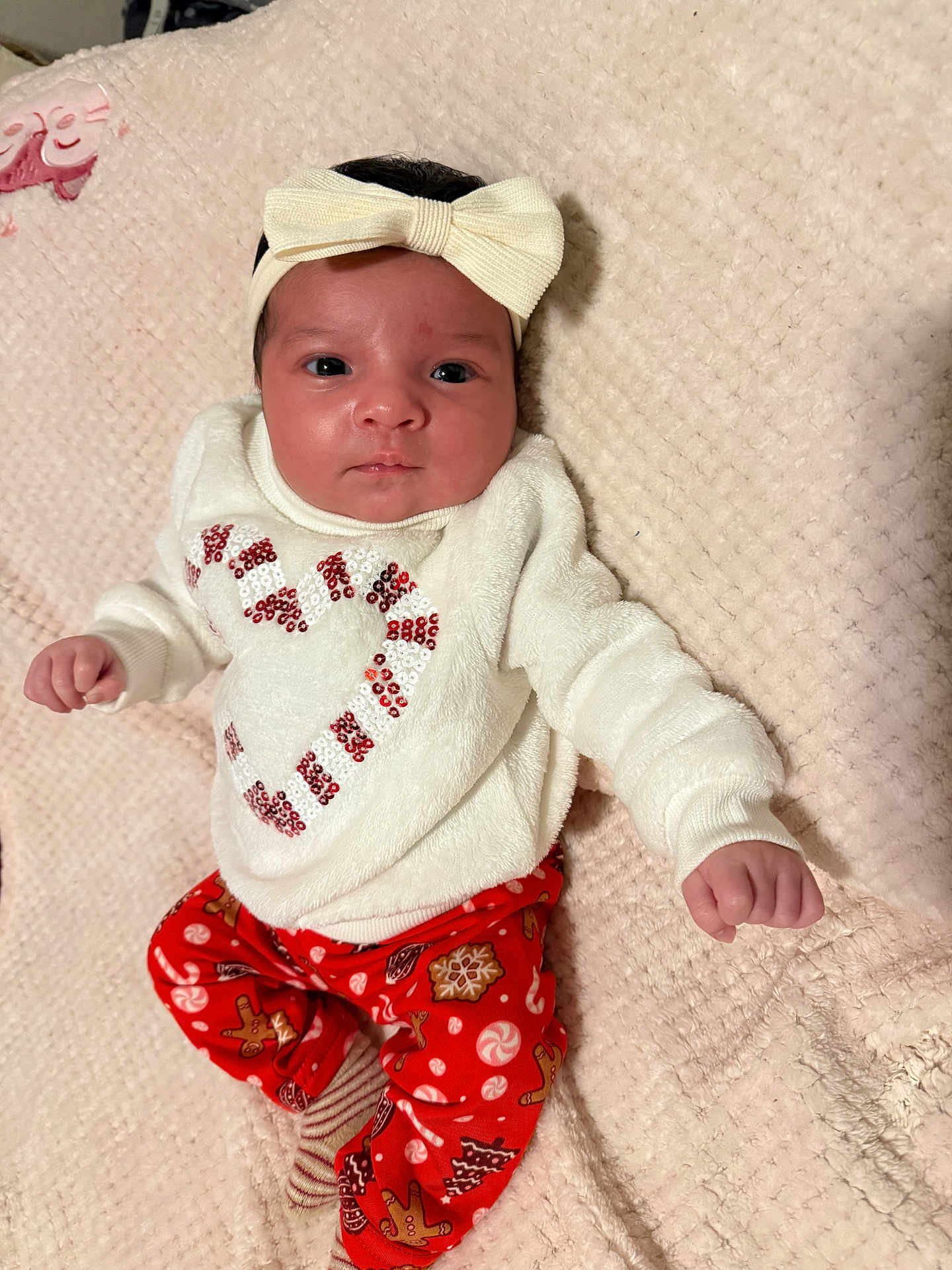 Kaylani joined the competition — help win amazing prizes! baby, infant, child, headband, bow, pajamas, holiday, christmas, candy_cane, heart, red_pants, white_sweater, blanket, soft_texture, lying_down, cute, portrait, indoors, smiling, festive