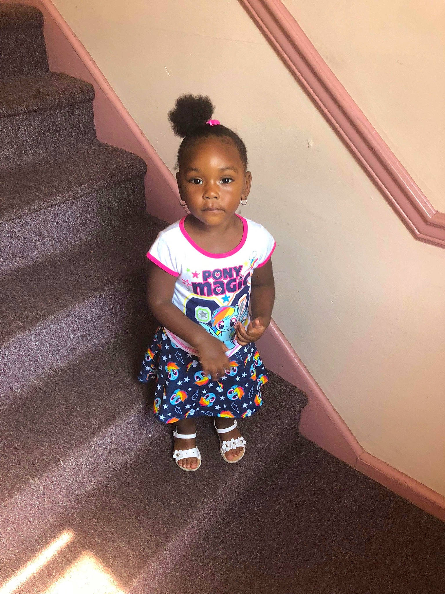 Kelani is registered to the contest to win money with this photo: child, floor, flooring, person, skin, smile, stairs, standing, toddler