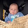 baby, infant, car_seat, blanket, pacifier, blue_clothing, face, head, person, child, indoor, seatbelt, safety, cute, expression, human, newborn, soft_texture, warm, comfort