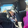 Elizabeth is registered to the contest to win money with this photo: child, toddler, car_seat, car_interior, seatbelt, sunlight, window, person, clothing, seat, headrest, hair, casual, road_trip, family, transportation, daylight, inside, safety, travel