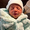 Tiago Hita Cortes a rejoint le concours — aidez-le/la à gagner de superbes lots ! newborn, baby, infant, hat, clothing, fluffy, cozy, face, closed_eyes, cute, warm, indoor, person, portrait, soft_texture, wrapped, sleepy, adorable, child, newborn_clothing