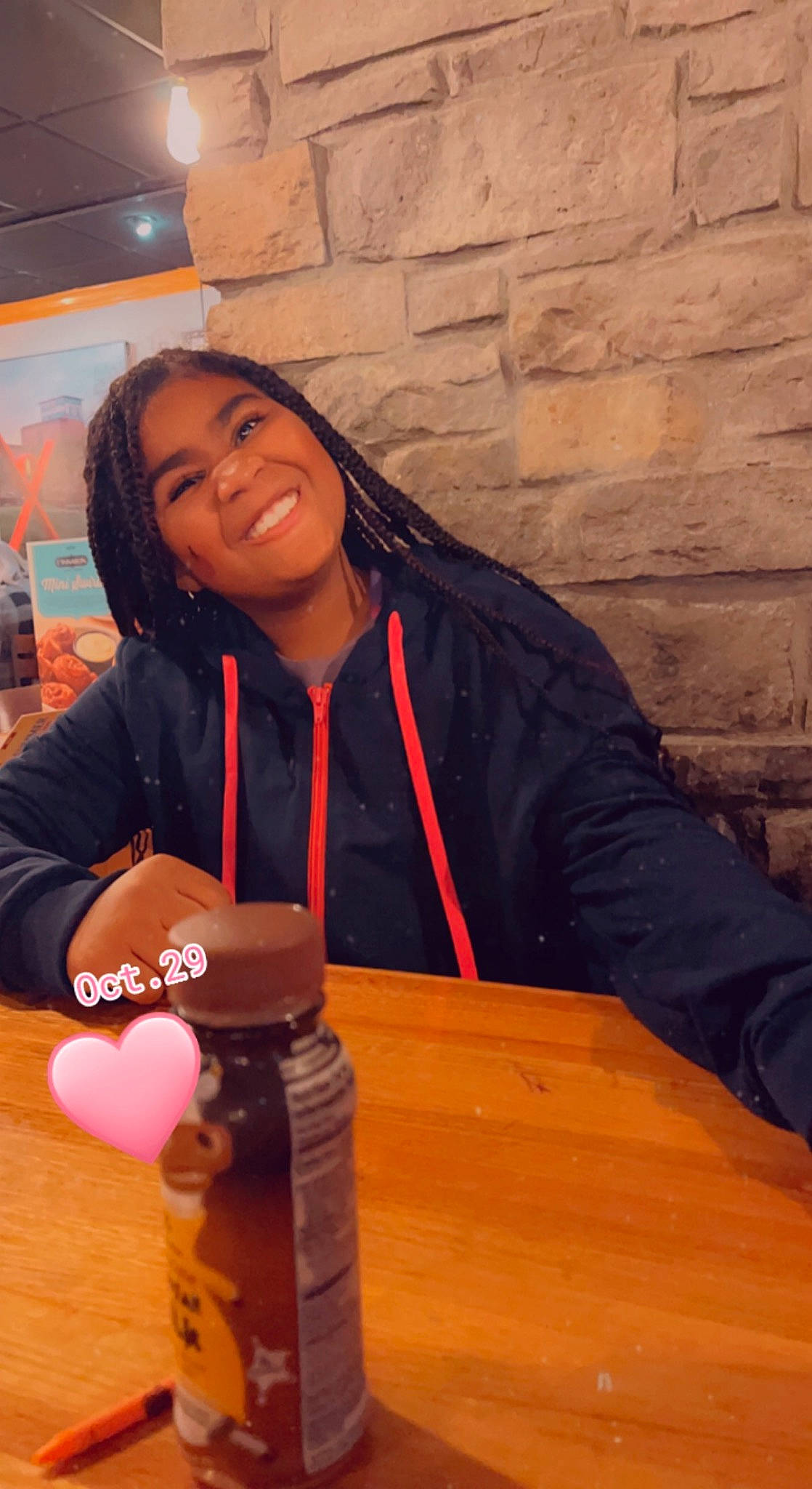 Kyra is registered to the contest to win money with this photo: audio_equipment, child, flooring, fun, happy, hardwood, hoodie, jacket, joy, leisure, person, recreation, room, sitting, sleeve, smile, table, toy, varnish, wood