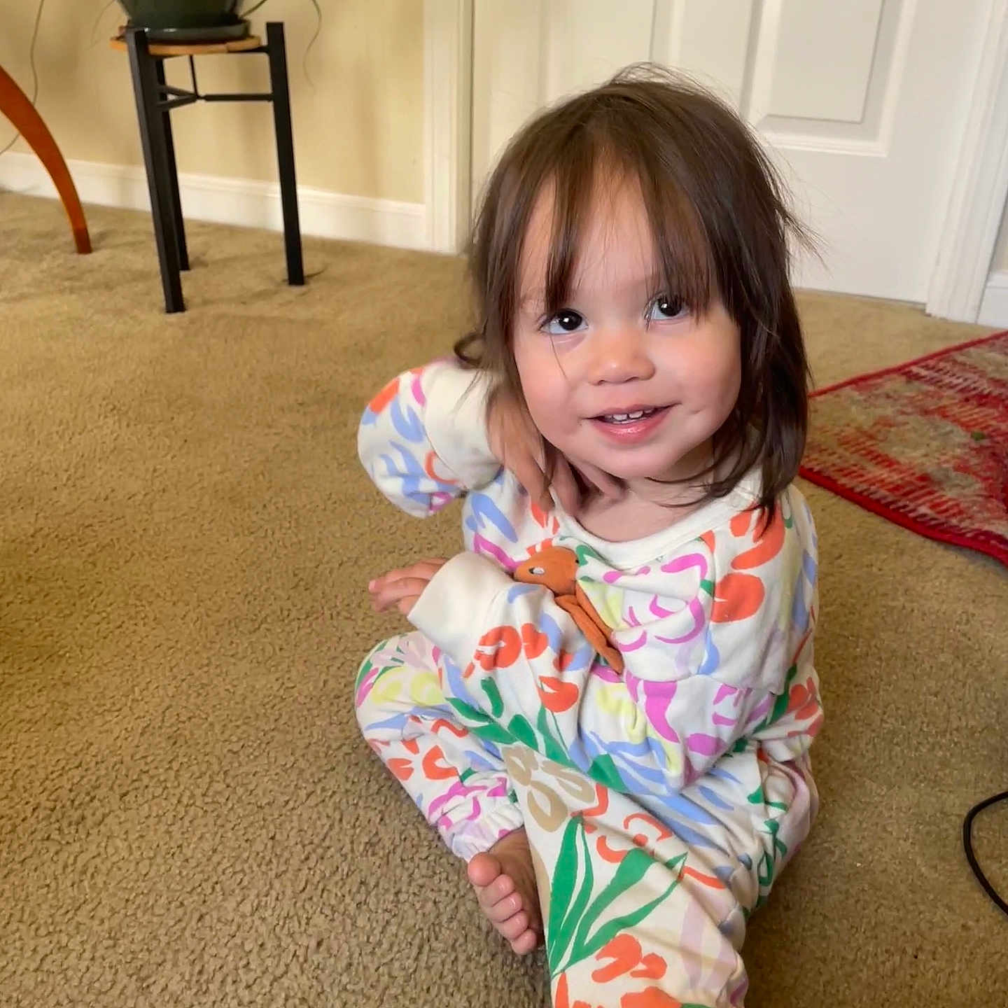 Isabel is registered to the contest to win money with this photo: americanfootball, americanfootballball, baby, ball, clothing, door, face, football, hardwood, head, pajamas, person, photography, plant, portrait, pottedplant, sitting, sleeve, sport, wood