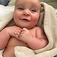 Arthur Harpole is registered to the contest to win money with this photo: baby, infant, blanket, smile, face, skin, hand, cute, child, young, portrait, indoors, soft, warm, cozy, expression, natural_light, wrapped, comfort, happy