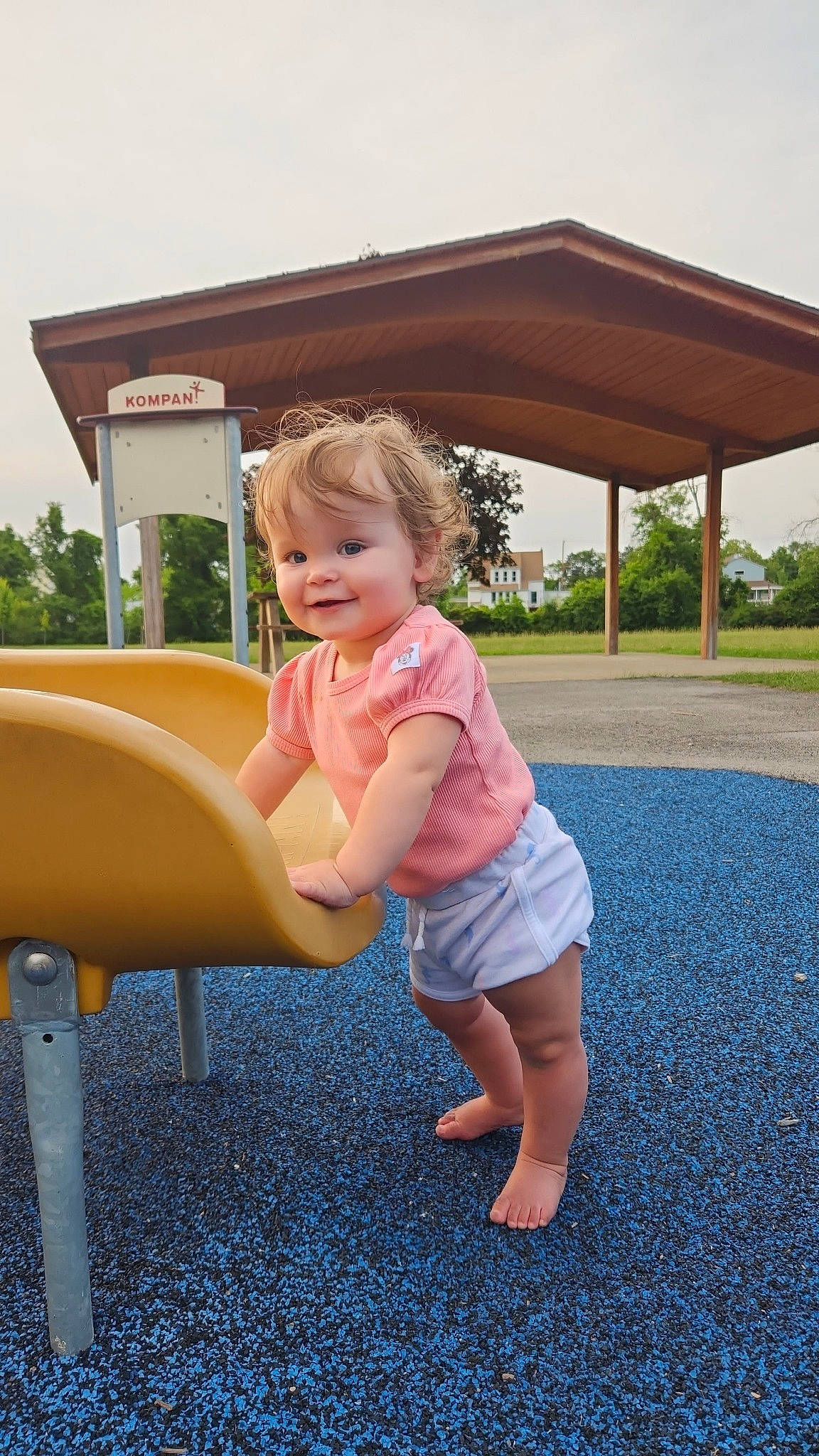 Harleigh joined the competition — help win amazing prizes! baby_toddler_clothing, blond, chute, city, fun, grass, human_settlement, joy, leisure, outdoor_furniture, outdoor_play_equipment, person, pink, plant, playground, playground_slide, recreation, shade, sky, smile