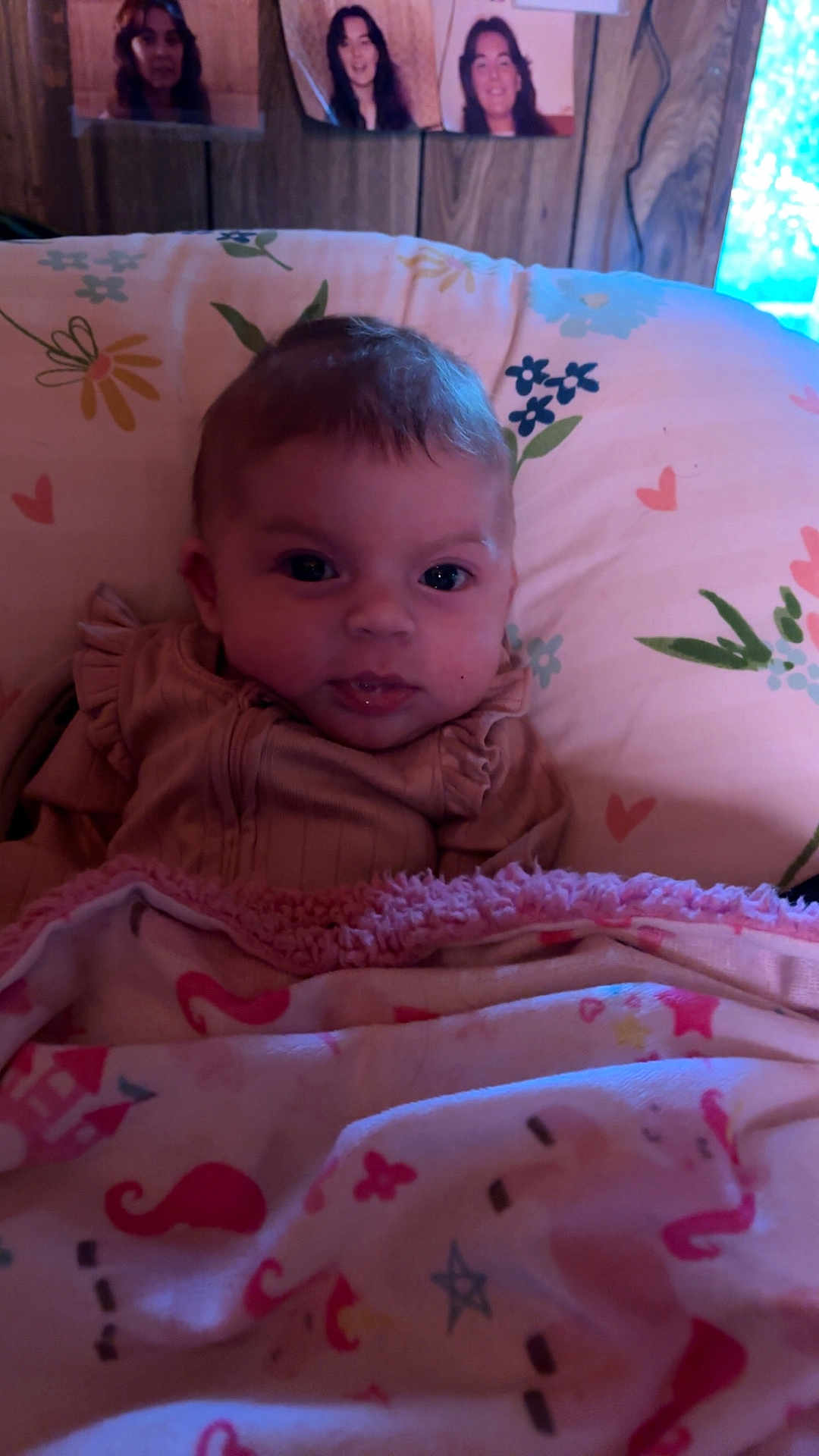 Willow joined the competition — help win amazing prizes! baby, blanket, cushion, floral_pattern, heart_pattern, wooden_wall, portrait, face, child, indoor, curly_hair, photography, soft_lighting, cozy, cute, expression, person, fabric, bedroom, decor