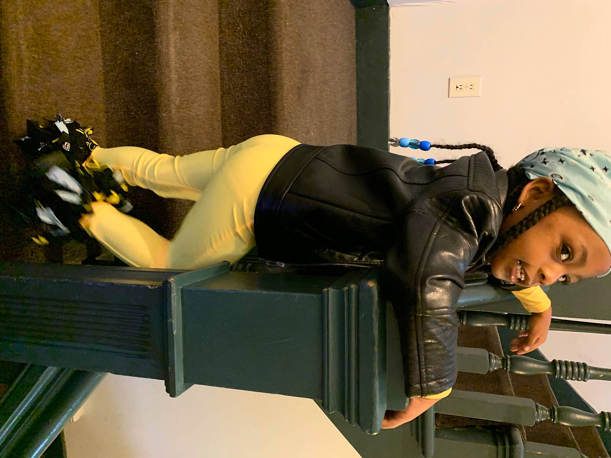 Anaj is registered to the contest to win money with this photo: baseball_cap, cap, chair, comfort, curtain, elbow, foot, hat, headwear, human_leg, knee, leisure, person, room, sitting, sportswear, table, thigh, toddler, waist