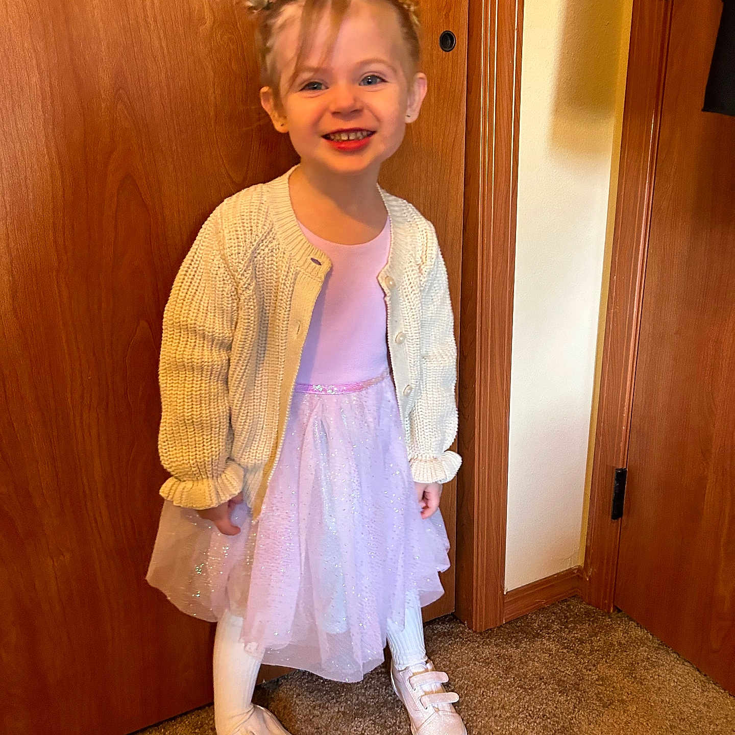 Amelia is registered to the contest to win money with this photo: child, clothing, coat, dress, face, female, footwear, girl, hardwood, head, knitwear, pants, person, photography, portrait, shoe, sleeve, standing, sweater, wood