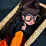 baby, sleeping, glasses, knit_hat, basket, blanket, cozy, cute, portrait, infant, sleep, hand, black_clothing, woven, soft, warm, child, resting, indoor, cute_outfit