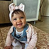 baby, child, smiling, indoor, headband, bow, pink, sweater, denim_overalls, white_tights, blanket, floral_pattern, floor, crawling, cute, happy, portrait, person, infant, cozy