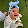 baby, child, smiling, headwrap, blue, outdoor, grass, happy, cute, floral, clothing, sitting, portrait, infant, face, young, person, joyful, headwear, playful