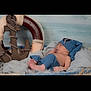 anchor, baby, blanket, blue_hat, blue_pants, cozy, cute, indoor, infant, life_preserver, nautical, newborn, peaceful, portrait, props, resting, sea, sleeping, soft_fabric, water
