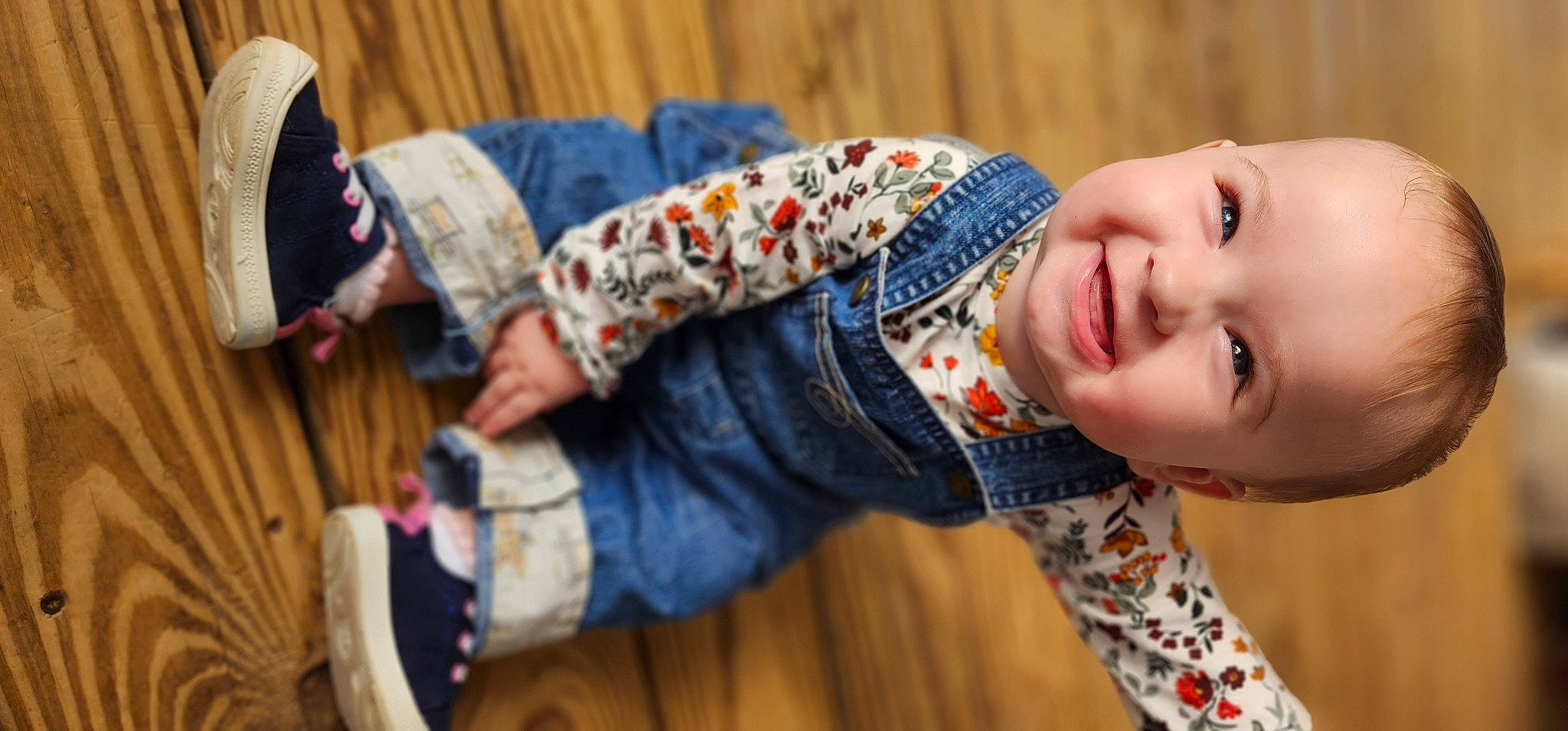 Aubrey joined the competition — help win amazing prizes! arm, baby, baby_toddler_clothing, child, comfort, facial_expression, finger, flooring, happy, hat, headgear, joy, outerwear, pattern, person, sitting, skin, sleeve, smile, textile