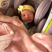 Octavia is registered to the contest to win money with this photo: newborn, baby, car_seat, blanket, pink, yellow_headband, sleeping, infant, cozy, cute, child, toddler, fabric, evenflo, resting, closeup, indoor, soft, person, headwear