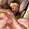 newborn, baby, car_seat, blanket, pink, yellow_headband, sleeping, infant, cozy, cute, child, toddler, fabric, evenflo, resting, closeup, indoor, soft, person, headwear