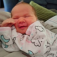 Berkley joined the competition — help win amazing prizes! baby, newborn, smiling, onesie, clothing, infant, face, sleeping, cute, child, soft, indoor, comfort, cozy, person, portrait, happy, resting, young, home