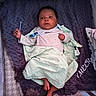 Sy'Meer Lopez joined the competition — help win amazing prizes! newborn, baby, infant, child, portrait, lying_down, bassinet, crib, blanket, pacifier, clothing, pink_shirt, sleeping_area, nursery, cushion, clouds, stars, feet, indoor, cozy