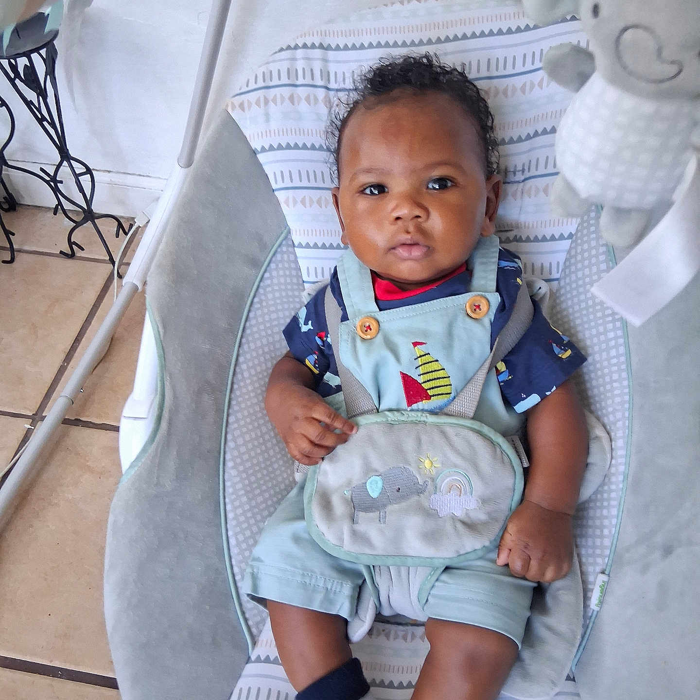 Sy'Meer Lopez joined the competition — help win amazing prizes! baby, infant, child, bouncer, seated, portrait, face, short_hair, sailor_outfit, sailboat, plush_elephant, stuffed_animal, blanket, baby_gear, indoor, floor, tile, home, socks, safe