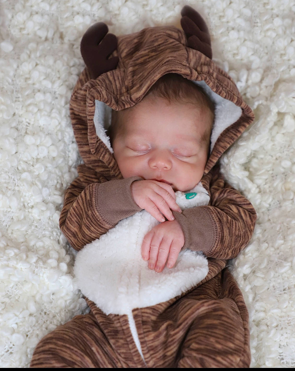 Elijah is registered to the contest to win money with this photo: baby, baby_products, baby_sleeping, baby_toddler_clothing, beige, bonnet, brown, cheek, comfort, costume_accessory, craft, creative_arts, fawn, knitting, person, product, skin, textile, thread, wool