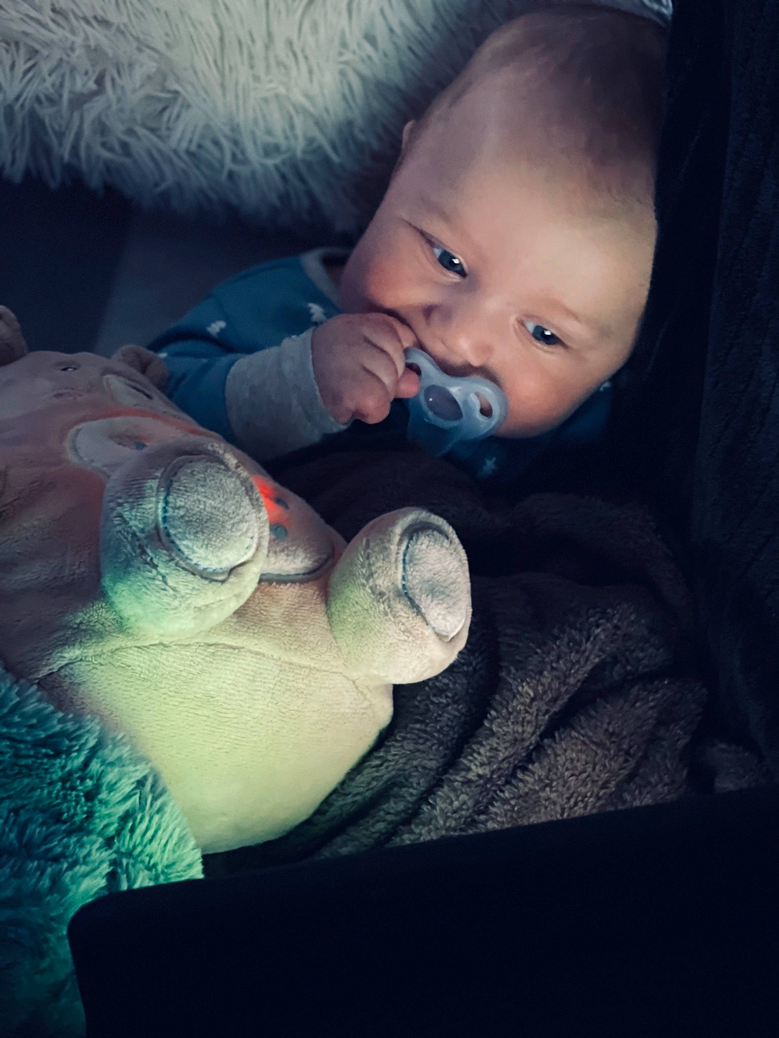 Elijah is registered to the contest to win money with this photo: baby, baby_products, baby_toddler_clothing, child, cloud, comfort, darkness, elbow, eye, finger, flash_photography, gesture, hand, happy, head, person, sitting, skin, textile, tints_and_shades