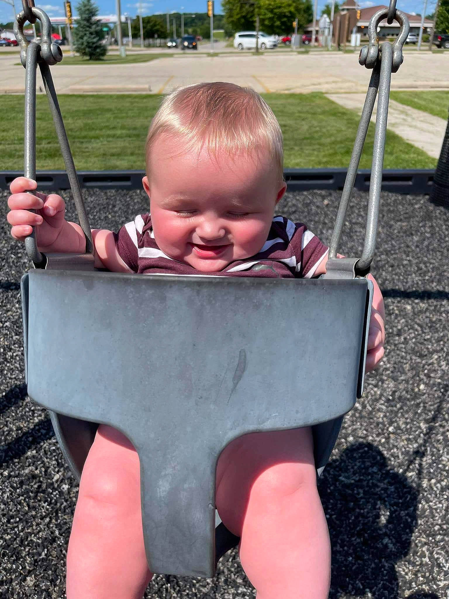 Kade joined the competition — help win amazing prizes! automotive_tire, baby, baby_toddler_clothing, child, city, fun, grass, happy, head, human_settlement, leisure, outdoor_play_equipment, person, plant, play, product, sky, smile, swing, toddler