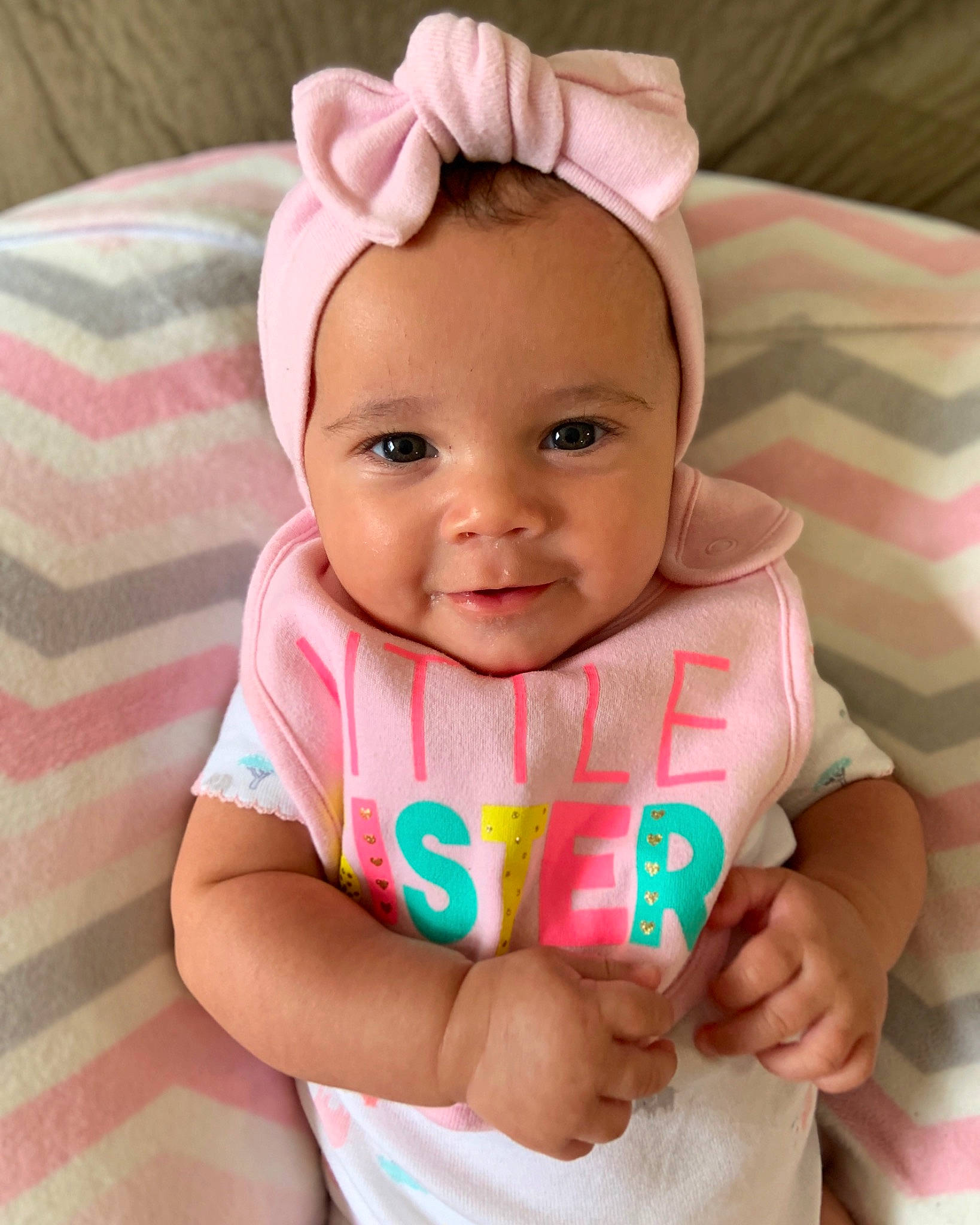 Carly is registered to the contest to win money with this photo: baby, baby_products, baby_toddler_clothing, cheek, child, ear, face, hair_accessory, head, headband, linens, neck, pattern, person, pink, skin, textile, toddler