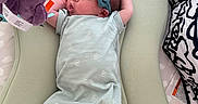 Maisie is registered to the contest to win money with this photo: newborn, baby, infant, child, portrait, lying_down, baby_nest, onesie, bow_headband, teal, mint_green, socks, plush_toy, purple_toy, nursery, cushions, blanket, indoor, sleepy, cozy