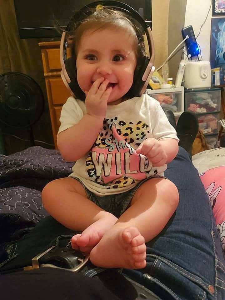 Esmeralda joined the competition — help win amazing prizes! baby, baby_toddler_clothing, chair, cheek, cool, eye, facial_expression, finger, fun, happy, head, human_leg, knee, lap, person, skin, smile, television, thigh, thumb