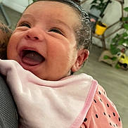 Elianna Rose joined the competition — help win amazing prizes! baby, smiling, infant, pink_clothing, bib, face, happy, person, indoor, plants, home_decor, closeup, joyful, cute, child, portrait, human, expression, holding, toddler