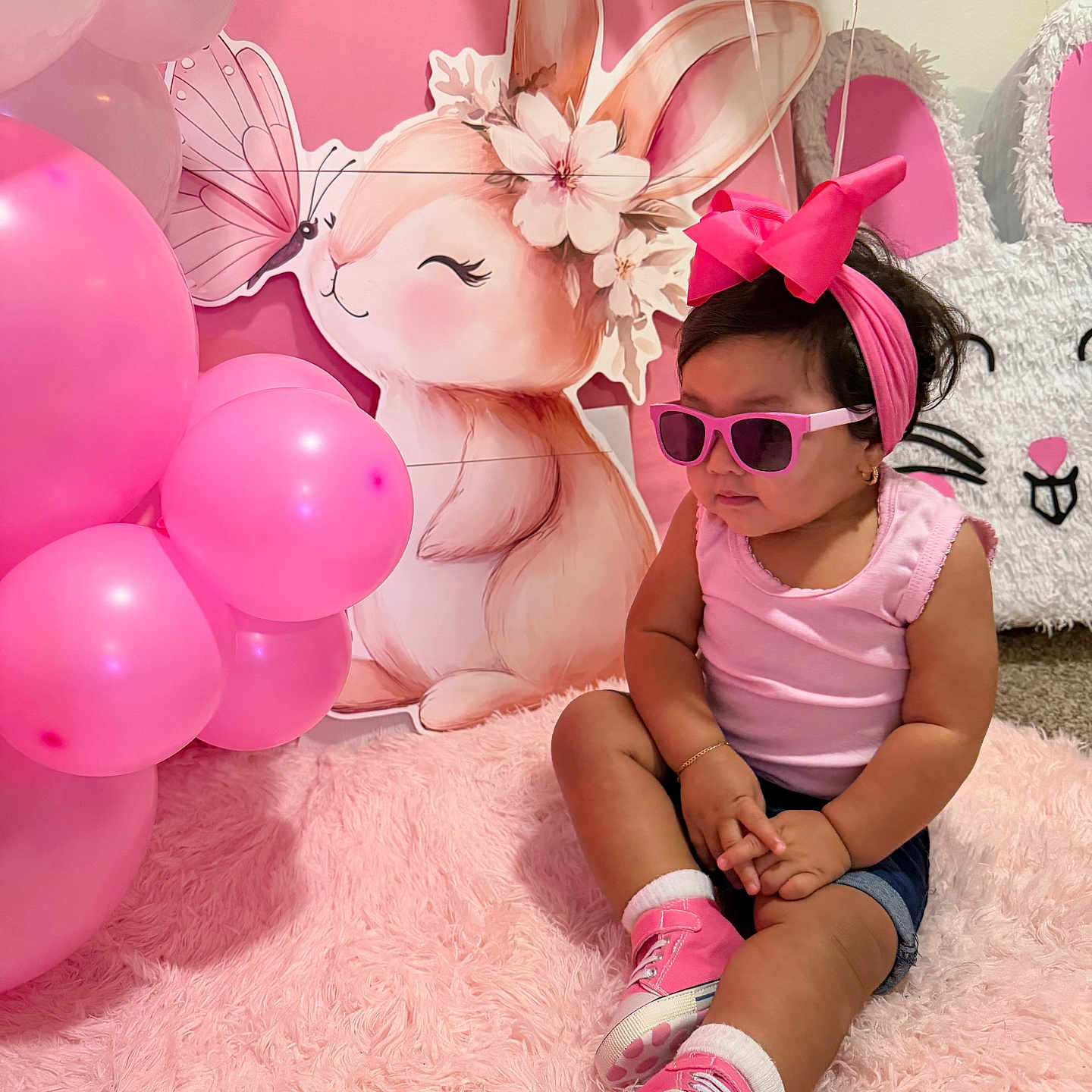 Manelick is registered to the contest to win money with this photo: toddler, child, pink, sunglasses, bow, balloons, fluffy_rug, bunny, decorations, indoor, cute, fashion, sitting, portrait, headband, smiling, shoes, shorts, happy, celebration