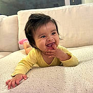 Vienna Grace joined the competition — help win amazing prizes! baby, child, couch, cute, face, fun, hand, happy, home, indoors, infant, person, pink_socks, playing, portrait, relaxed, smiling, soft_furniture, yellow_clothing, young
