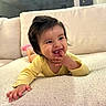 baby, child, couch, cute, face, fun, hand, happy, home, indoors, infant, person, pink_socks, playing, portrait, relaxed, smiling, soft_furniture, yellow_clothing, young