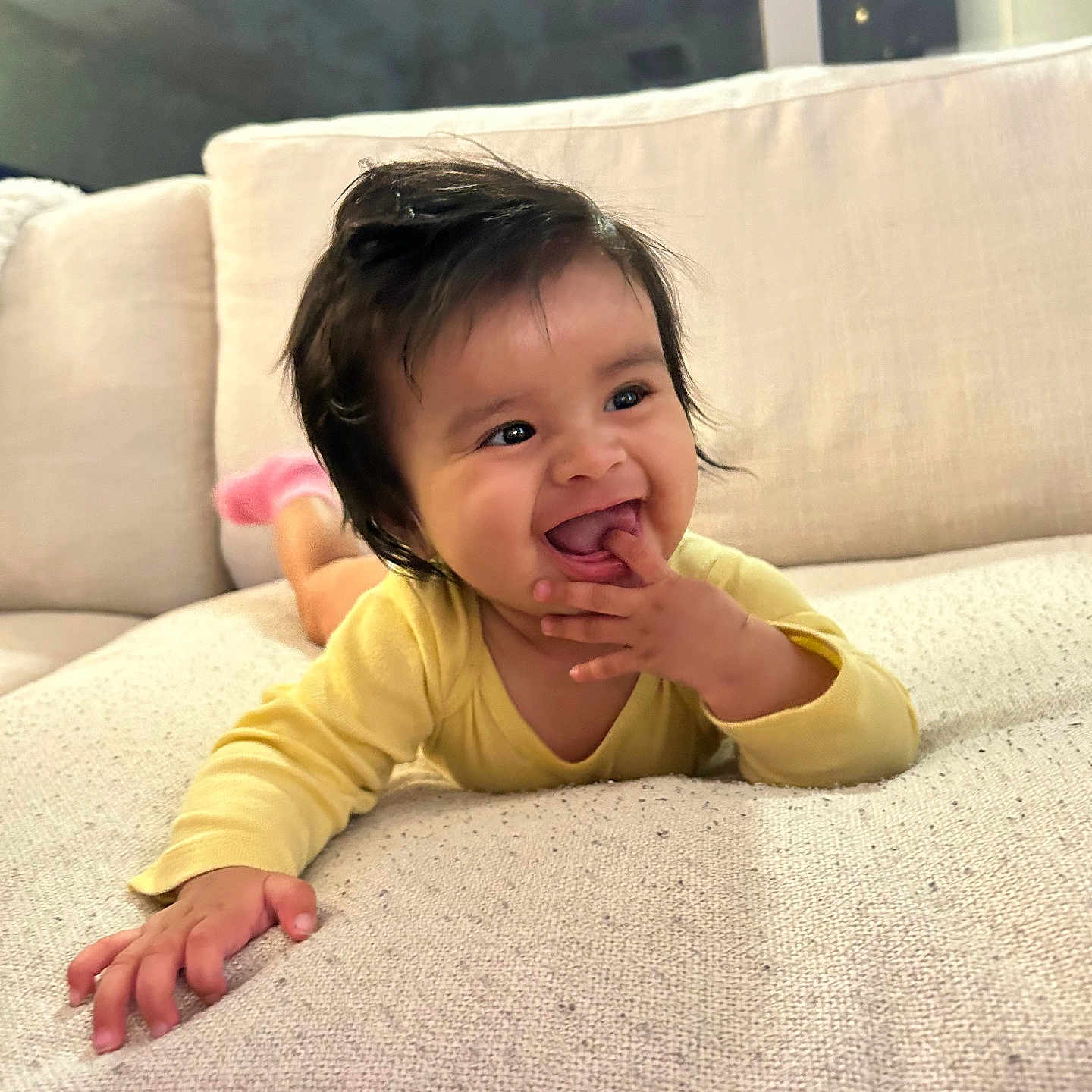 Vienna Grace joined the competition — help win amazing prizes! baby, child, couch, cute, face, fun, hand, happy, home, indoors, infant, person, pink_socks, playing, portrait, relaxed, smiling, soft_furniture, yellow_clothing, young