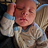Howard is registered to the contest to win money with this photo: baby, sleeping, pajamas, infant, hand, face, person, indoor, closeup, cozy, child, resting, cute, soft_lighting, patterned_clothing, young, peaceful, nap, skin, relaxation