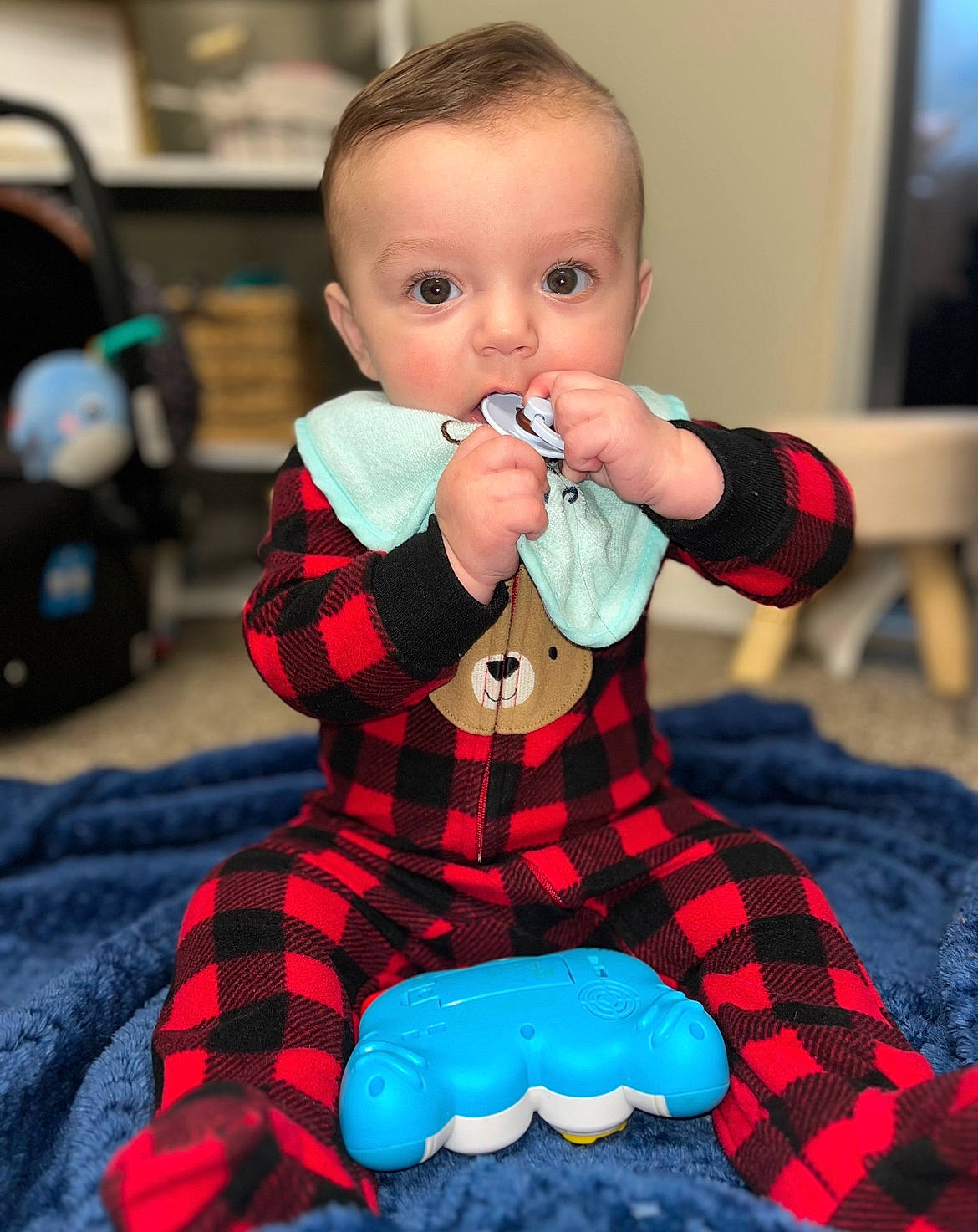 Kamden is registered to the contest to win money with this photo: baby, baby_products, baby_toddler_clothing, blue, cheek, child, design, electric_blue, event, fun, hairstyle, happy, pattern, person, photograph, plaid, sitting, sleeve, surprise, tartan